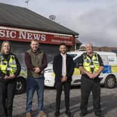 Coun Tom Hollis and Antonio Taylor, council community safety manager, with council community protection officers on the Carsic Estate. Photo: ADC