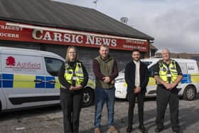 Coun Tom Hollis and Antonio Taylor, council community safety manager, with council community protection officers on the Carsic Estate. Photo: ADC