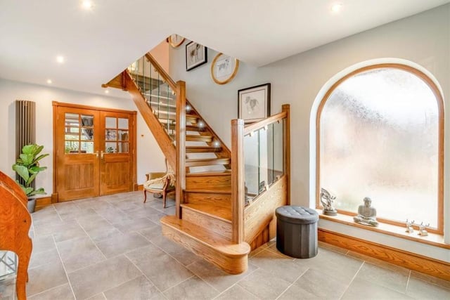 The welcoming, L-shaped hallway, which is where we begin our tour of the Pleasley Vale property, sets the tone for the rest of the house. It is a classy space, with tiled flooring, ceiling spotlights and a stunning, bespoke staircase with a glass balustrade.