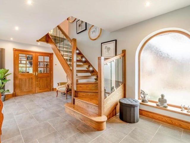 The welcoming, L-shaped hallway, which is where we begin our tour of the Pleasley Vale property, sets the tone for the rest of the house. It is a classy space, with tiled flooring, ceiling spotlights and a stunning, bespoke staircase with a glass balustrade.