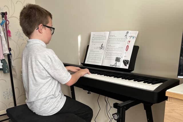 Kian Arundell, a chorister of St Mary Magdalene, Newark, tries out one of the new pianos.
