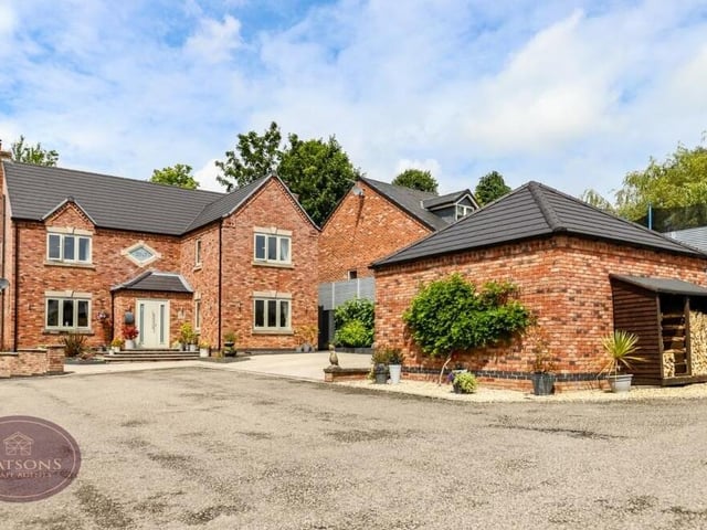 We close our gallery with a shot of the sizeable resin driveway at the front that has off-street parking space for four vehicles. You can also spot a double log-store to the right, behind the garage.