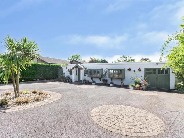 Outside, the property boasts a low-maintenance front garden, a driveway for off-street parking, and an integral garage/store.