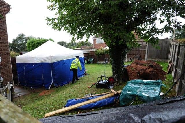 Police in the rear garden of the house in Blenheil Close, where the Wycherley's remains were unearthed