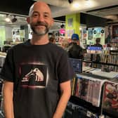 Steve Cohan, HMV staff member, is all smiles in the Mansfield store - watching the 'Live and Local' event back in July.