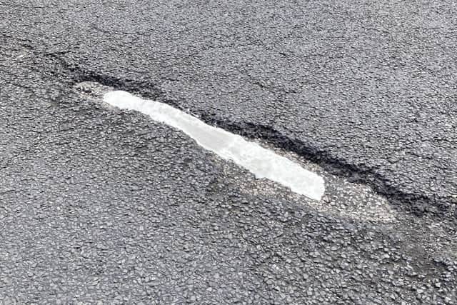 Another image shows a repainted road line in a pothole. Southwell Road, Mansfield.