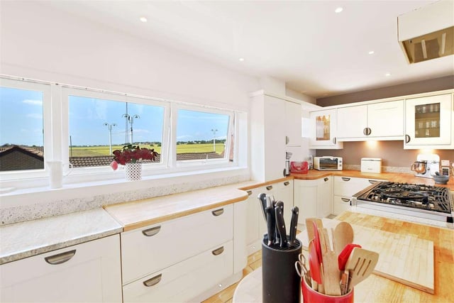 Located at the street-end of the property, this kitchen comes fitted with an excellent range of modern wall and base units along with a combination of wood and granite worktops. The open-plan space allows beach views from the front to the rear.
