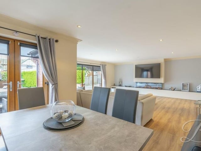 The living area extends into this delightful dining area, which has folding doors leading into the kitchen.