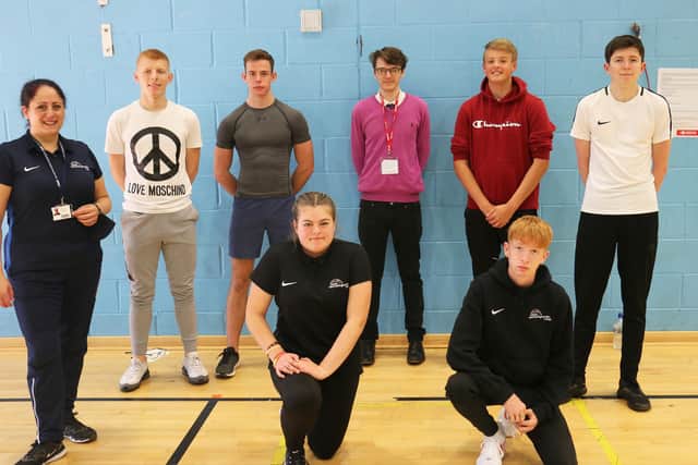 Former student Damon Butcher (back, centre) helped Marian Higgins' students with their current assignment