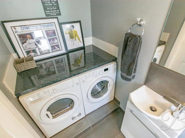 The downstairs toilet doubles up as a utility room with space and plumbing for a washing machine and tumble dryer.
