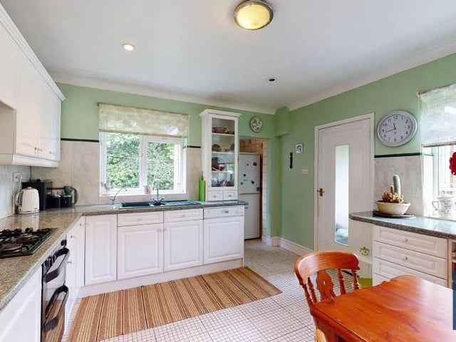 A second view of the bright and spacious dining kitchen. Other features include a four-ring gas hob, a double oven, an integrated dishwasher, an Asterite bowl-and-a-quarter sink unit with mixer tap, and rolled-edge work surfaces. There is also a useful utility area with space and plumbing for a washing machine and space for a larder fridge freezer.