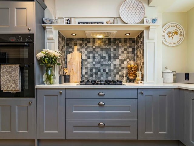 Integrated appliances in the dining kitchen include a waist-high double electric oven,  five-ring gas hob with extractor over, fridge/freezer and dishwasher. Adding to the style of the room are a wood-effect laminate floor and ceiling spotlights.