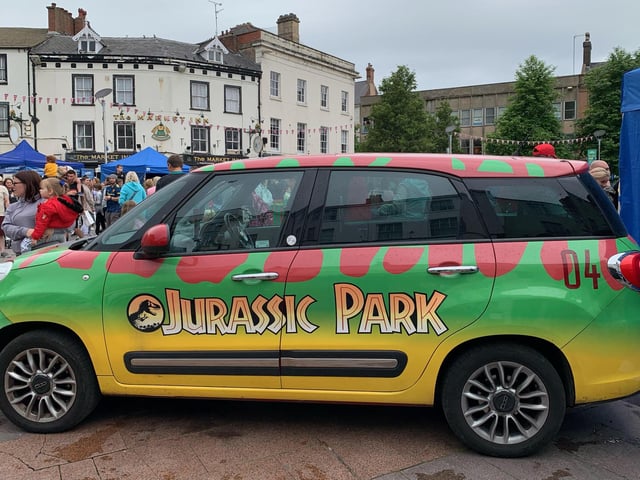 Children posed for photos with the iconic Jurassic Park vehicle.