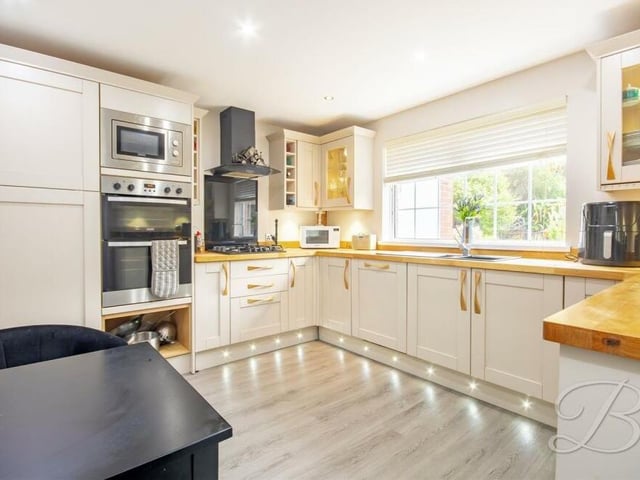 The kitchen provides the perfect setting for preparing meals. Appliances include an integrated oven, microwave, gas hob and extractor fan. As well as downlights, the window, facing the back of the house, offers plenty of natural brightness.