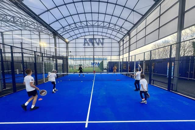 Action shot from one of four covered Padel courts.