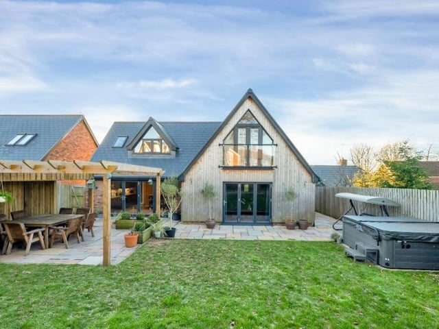 Here is a wide angle view of the rear of the £470,000 property that again underlines its individual design. You can see one set of bi-folding doors on the ground floor, leading out to the patio, and the Juliet balcony in bedroom three on the first floor.