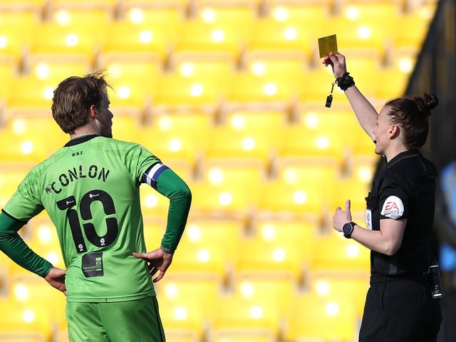 Rebecca Welch shows a yellow card to Tom Conlon.