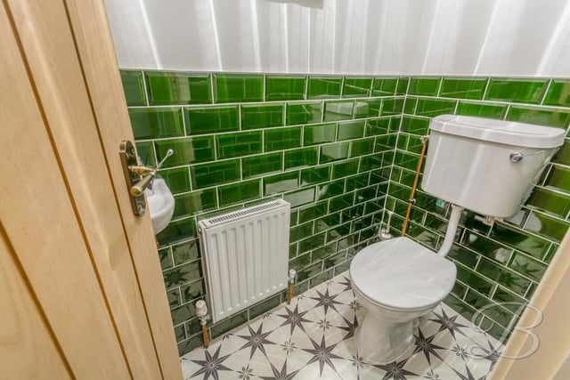 Off the hallway is this sparkling loo, complete with low-flush WC, hand wash basin and central heating radiator.