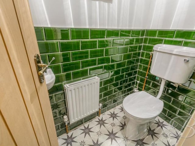 Off the hallway is this sparkling loo, complete with low-flush WC, hand wash basin and central heating radiator.