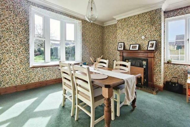 The delightful dining room is the ideal spot for sit-down family meals or for entertaining friends. It has a carpeted floor, gas fireplace and windows to the side and rear of the Walesby property.