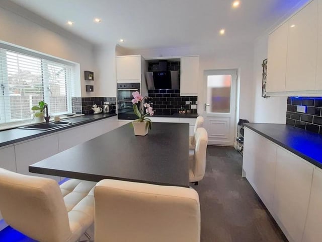 A second shot of the kitchen. Built-in appliances include an electric hob, electric double fan-assisted oven, dishwasher and fridge freezer. There is also a one-and-a-half bowl drainer sink unit with mixer tap.