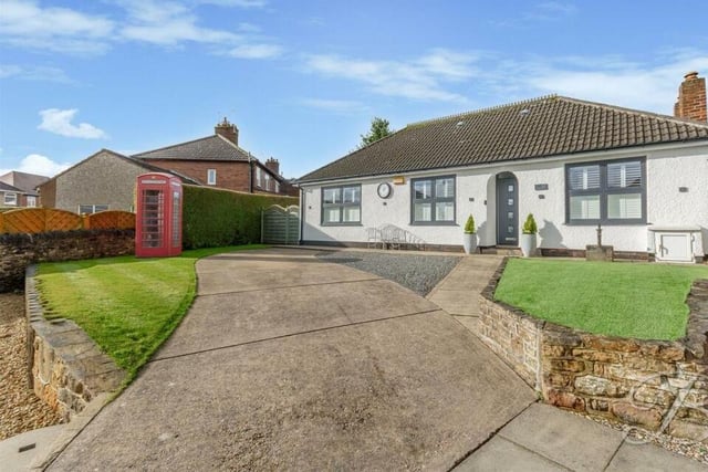 We close our gallery with another look at that feature telephone box in the front garden, which also includes a neat lawn and decorative slate borders.