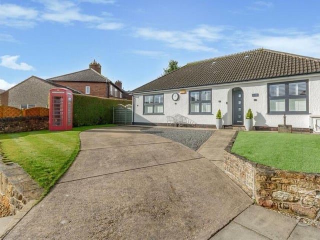 We close our gallery with another look at that feature telephone box in the front garden, which also includes a neat lawn and decorative slate borders.