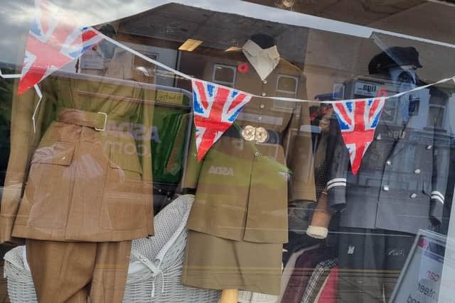 The shop window at the Headway charity shop on Station Road, Kirkby, with its current display to mark Remembrance Day