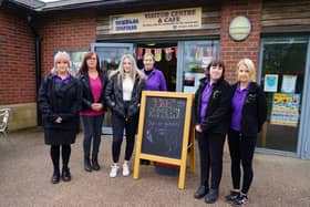 Staff with 'Save Rumbles' sign at Rumbles Community Cafe this morning (September 26).