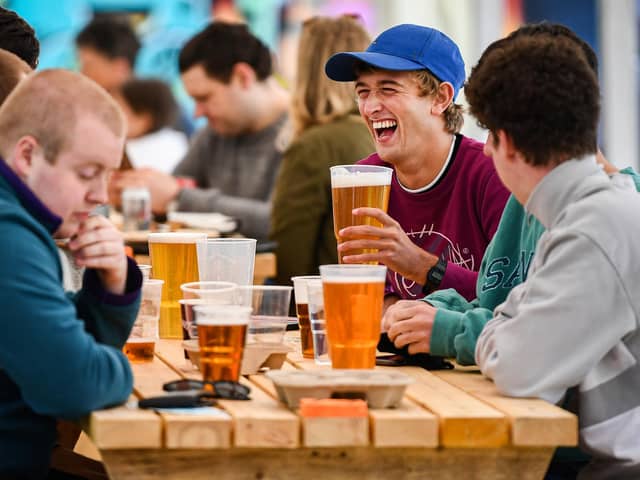 Members of the public enjoy their first drink in a beer garden (Photo by Jeff J Mitchell/Getty Images)