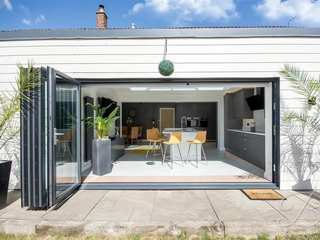 A large skylight and expansive bifolding doors fill the open plan kitchen space with natural light and provide effortless access to the rear garden.