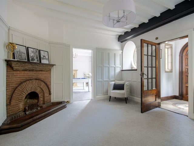 A second shot of the reception hallway, showing an original fireplace.