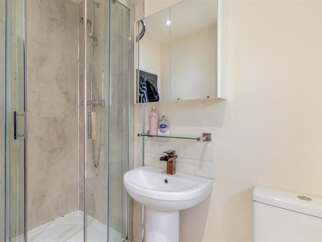 The first floor is home to a shower room, which is fitted with a modern three-piece suite. It comprises a tiled shower cubicle, pedestal wash hand basin and low-flush WC. There is also a heated towel-rail, three ceiling spotlights and an airing cupboard housing a gas-fired combi boiler.
