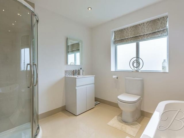The last room we look at inside the house is this family bathroom. It comes complete with a standalone, fitted bath, separate walk-in shower cubicle, low-flush WC, vanity hand wash basin and downlights.