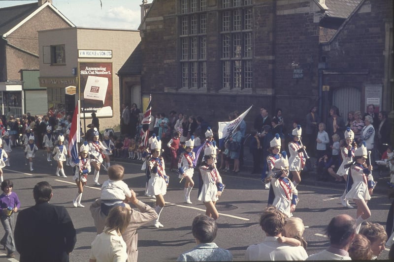 A carnival parade marches outside the public library, which is now the Daylight Centre.