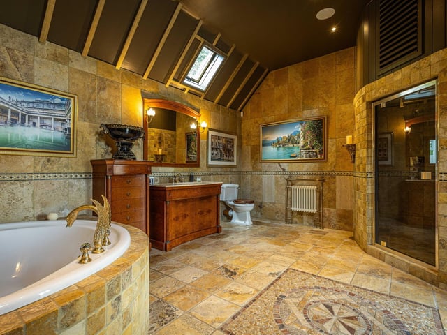 A luxuriously fitted bathroom has a host of spa conveniences to hand