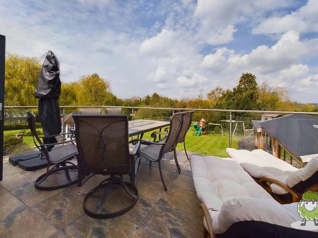 The dining room opens out on to this amazing balcony, which offers views over the back garden and the surrounding countryside.