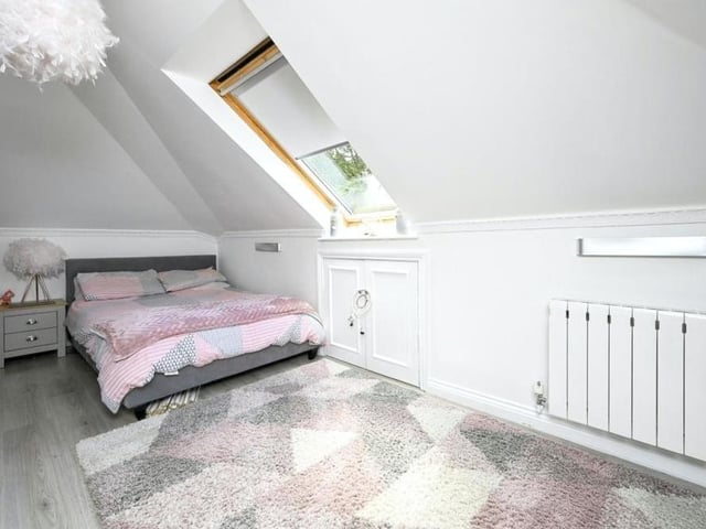 The last of the five bedrooms, again with a skylight and also laminate flooring.