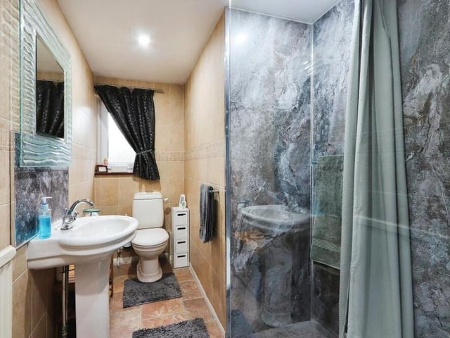 The final photo from the annexe at the £960,000 Selston property captures the shower room. It has a walk-in shower, sink and low-level WC.