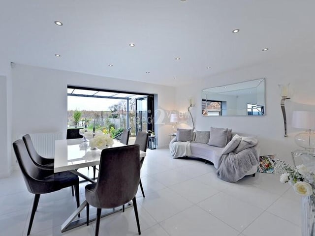 The dining area from a different angle, showing how uPVC double-glazed bi-folding doors open out on to a pleasant patio in the rear garden.