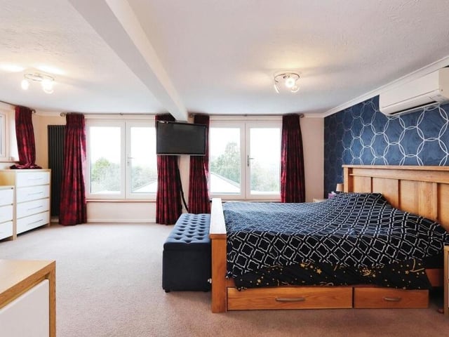 The first floor houses five of the six bedrooms, most notably this marvellous master, which is incredibly spacious and boasts superb views of the back of the £960,000 property. Three of the bedrooms are blessed with air conditioning.