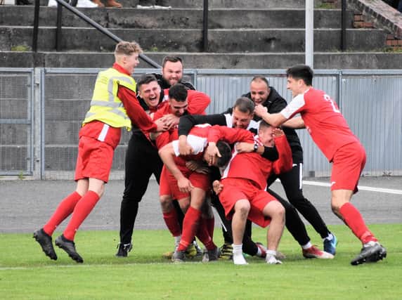 AFC players celebrate the winner against Hanley Town in the FA Vase.