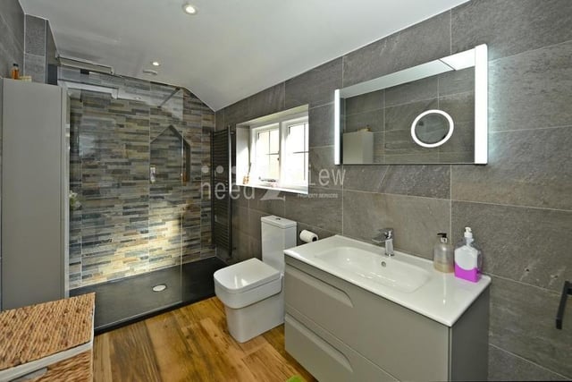 The master bedroom has its own en suite in the shape of this smart shower room that has been recently fitted. A modern three-piece suite comprises a walk-in shower enclosure, close-coupled WC and wash hand basin set into a vanity unit. There is also a heated towel-rail and wall-mounted anti-mist mirror.