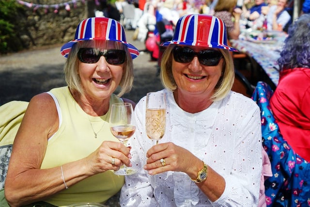 Janet and Debbie Broadhurst celebrating in matching hats at the Teversal street party.