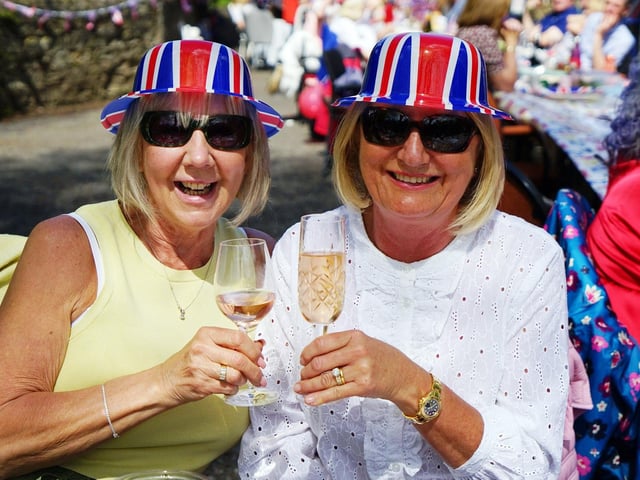 Janet and Debbie Broadhurst celebrating in matching hats at the Teversal street party.