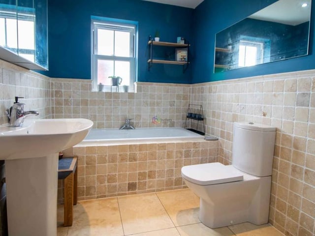 The family bathroom is an appealing space, especially with its half-height tiles. There is a white bath, with window above, a wash hand basin on a pedestal, a WC and a shower cubicle. There are two doors, one leading to the landing and one to bedroom two, creating a Jack and Jill effect.