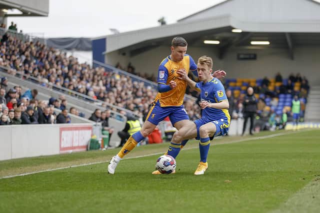 Callum Johnson takes on his man at the Cherry Red Records Stadium. Photo by Chris Holloway / The Bigger Picture.media