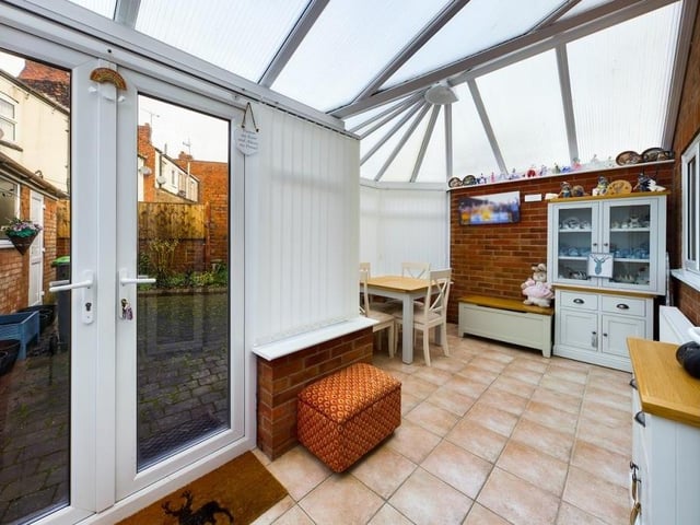 A second shot of the conservatory, which is full of natural light and has doors leading out to the garden.
