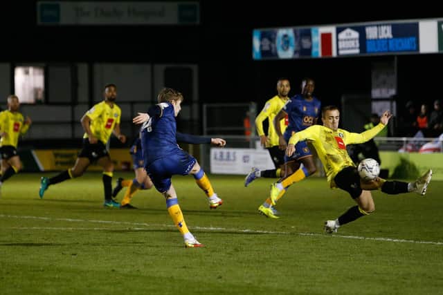 Mansfield Town defender Elliott Hewitt shoots towards the Harrogate goal. Photo by Chris Holloway/The Bigger Picture.media
