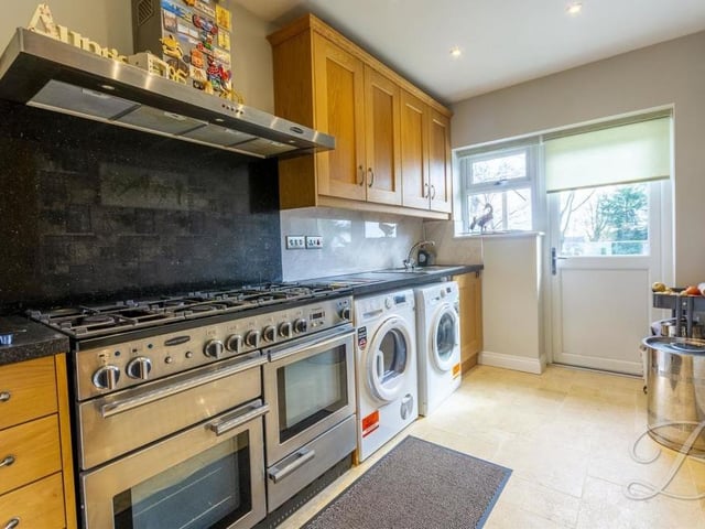 Just off the kitchen is this impressive utility room, which has space for a Rangemaster dual-fuel oven, a washing machine and tumble dryer. The room comes complete with a range of wall and base units, plus work surface over and inset sink and drainer.